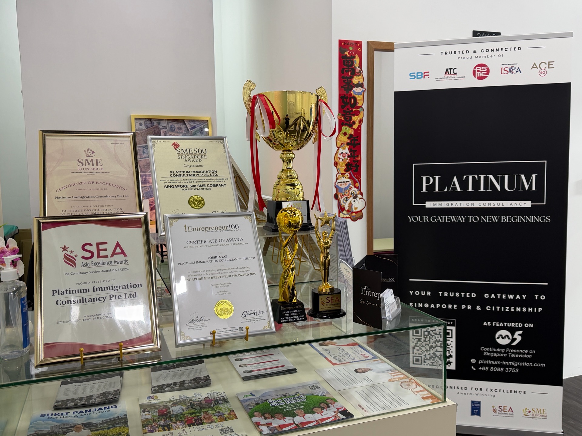 Awards and certificates on display at Platinum Immigration Consultancy's office